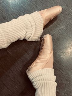 a woman's feet wearing ballet shoes and socks