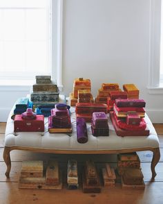 a white bench topped with lots of different colored boxes