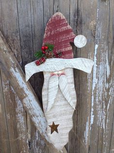 a christmas stocking hanging on the side of a wooden door with an ornament