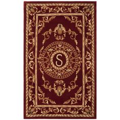 a red and gold rug with the letter s on it's center, surrounded by ornate