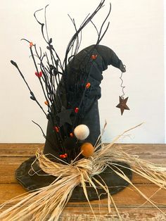 a witches hat with brooms and decorations on a table