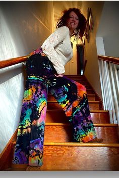 Reverse Rainbow Dyed Palazzo pants that have a fold down yoga band and come in sizes XS-5X. These pants have been reverse dyed to remove color then carefully hand dyed using low impact dyes. These pants feature a lightweight fabric with great stretch for comfort and have double stitching on bottom hem to withstand time. These pants are unlined. 95% RAYON 5% SPANDEX We would like to note that they are pre-shrunk CARE All leggings are hand dyed by me, machine washed and dried many times in all wat Multicolor Relaxed Fit Hippie Bottoms, Multicolor Relaxed Fit Hippie Pants, Relaxed Fit Multicolor Hippie Bottoms, Hippie Multicolor Relaxed Fit Pants, Hippie Style Multicolor Relaxed Fit Pants, Tie Dye Wide Leg Bottoms With Relaxed Fit, Tie Dye Relaxed Fit Wide Leg Bottoms, Relaxed Fit Tie Dye Wide Leg Bottoms, Wide Leg Yoga Pants For Festivals