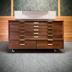 a large wooden dresser with a printer on top