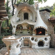 an outdoor pizza oven in the middle of a patio