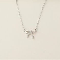 This Posting Is For One Silver Colored Bow Necklace. Very Timeless Piece Of Jewelry. Super Cute For An Adult Or Young Woman. Wonderful Costume Piece Of Jewelry For Your Collection. Condition: Brand New Color: Silver Fast And Careful Shipping! Prom Jewlrey Looks Silver, Dainty Rhinestone Choker For Party, Dainty Rhinestone Necklace With Clavicle Chain For Parties, Dainty Rhinestone Clavicle Necklace For Parties, Dainty Rhinestone Necklace With Adjustable Chain For Party, Delicate Cubic Zirconia Necklace For Party, Dainty Silver Rhinestone Necklace For Party, Dainty Clavicle Chain Bridal Necklace For Party, Dainty Bridal Clavicle Chain Necklace For Party