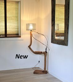 a lamp that is sitting in the corner of a room next to a mirror and window