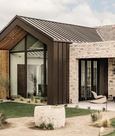 a modern house with stone and wood accents