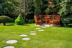 a wooden table sitting on top of a lush green field