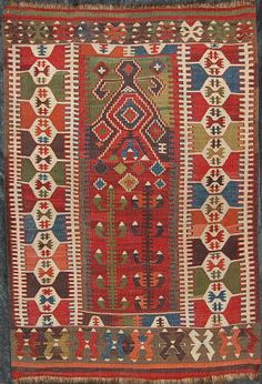 an old rug with many different colors and patterns