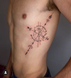 a man with a compass tattoo on his chest