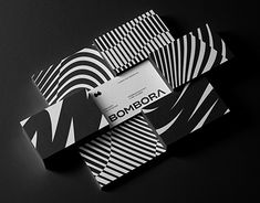 an assortment of black and white folded papers