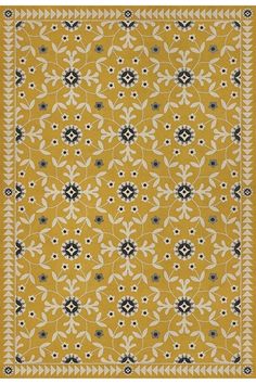 a yellow rug with black and white designs on it