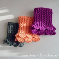 three crocheted scarves laying on top of each other