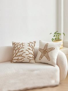 a white couch with two starfish pillows on it