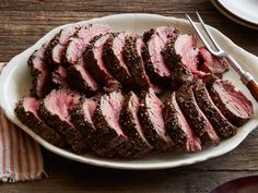 sliced steak on a plate with a fork