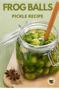 a jar filled with pickles sitting on top of a wooden cutting board