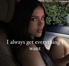 a woman sitting in the back seat of a car