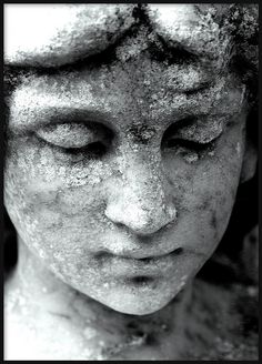 a black and white photo of a woman's face covered in powdered dirt