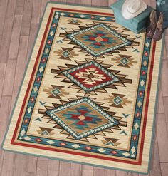 an area rug on the floor with a blue vase and white chair next to it