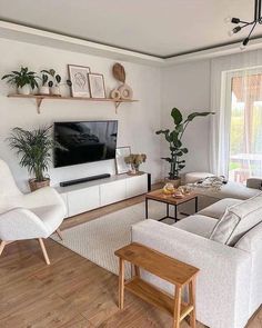 a living room filled with furniture and a flat screen tv on top of a wall