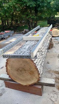 a large wooden log sitting on top of a cement ground