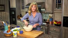 a woman is mixing something in a bowl