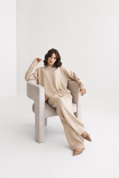 Indulge in comfort with these beige loungewear wide-leg pants, crafted from soft, luxurious Italian merino wool. With their cozy feel and versatile camel hue, they are perfect for lounging at home or stepping out in style. These pants effortlessly combine elegance and ease, making them a must-have staple for your wardrobe. EVERY KNITTED ITEM HAS A STORY, PEOPLE, AND TRADITIONS BEHIND IT - Our creations come to life in a Lithuanian artisan workshop, within small family-run businesses. The artisan Beige Loungewear, Knitted Loungewear, Pull Oversize, Pantalon Large, Loungewear Set, Merino Wool Sweater, Relaxed Style, Women Pullover, Wide Leg Trousers