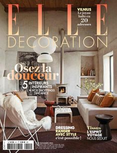 a living room filled with furniture on top of a magazine cover next to a fire place