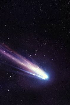 an image of a comet in the sky with stars around it and one light emitting from its tail