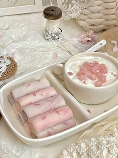 two trays filled with food on top of a white table covered in doily