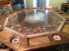 a wooden table topped with lots of bottle caps