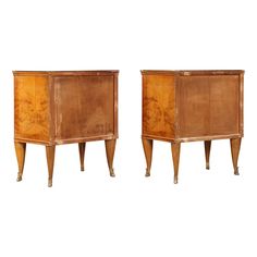 a pair of wooden cabinets sitting next to each other on top of a white background