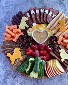 a platter filled with fruits, vegetables and crackers