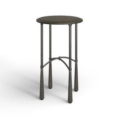 a small round table with two metal poles on the top and one leg in the middle