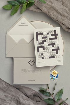 an envelope with a crossword puzzle on it next to a piece of wax paper