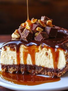 a piece of cheesecake on a plate with chocolate sauce and caramel toppings