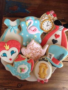 decorated cookies in the shape of teapots and flamingos