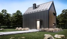 a small house in the middle of a grassy area with rocks and grass around it