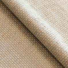 a close up shot of a tan woven fabric with small squares on the outside of it