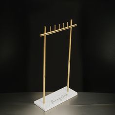 a white marble and gold colored display stand with four candles on it, which reads jimmy crock