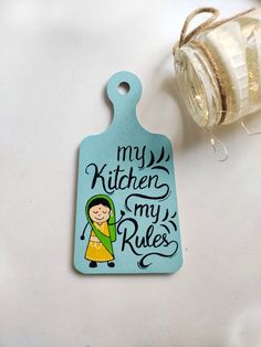 a tag that says, my kitchen is my rules on it next to a jar of honey