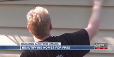 a man in black shirt standing next to a house with the words building a better obama on it