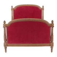 an antique style bed with red velvet headboard and foot board, on white background