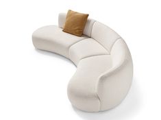 a white couch with a brown pillow on it's back and two pillows on top