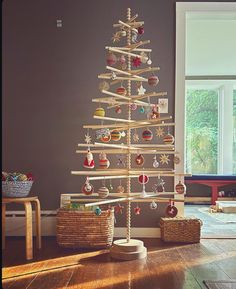 a wooden christmas tree with ornaments on it