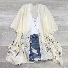 Get ready for spring/summer with our Daisy Embroidered Kimono! This playful and quirky piece will add a pop of color to any outfit. Featuring delicate embroidered daisies, this kimono is the perfect mix of fun and feminine.  One Size fits 0-14 Embroidered V-neck Kimono For Spring, Cotton V-neck Kimono With Floral Print, Spring Loungewear Tops With Kimono Sleeves, Casual Cotton Kimono For Loungewear, Casual White Spring Kimono, Casual White Kimono For Spring, Spring Tops With Relaxed Fit And Kimono Sleeves, Spring Tops With Kimono Sleeves And Relaxed Fit, Relaxed Fit Tops With Kimono Sleeves For Spring