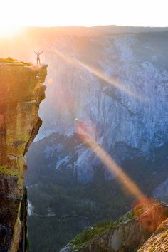 a man standing on the edge of a cliff