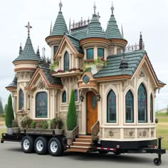 a large truck with a house on the back of it's flatbed trailer