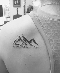 a woman with a mountain tattoo on her upper arm and the words matter written in black ink