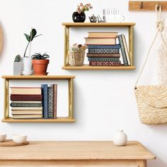 three wooden shelves with books and plants on them in front of a wall mounted clock